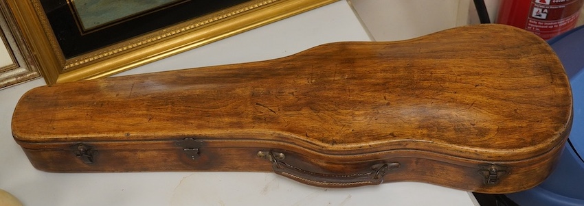 A late 19th century violin, bears fake Stradivarius label, cased, back measures 36cm. Condition - fair